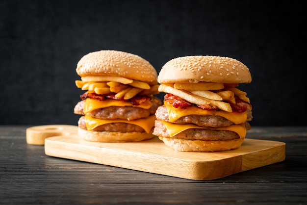 pork hamburger or pork burger with cheese, bacon and french fries