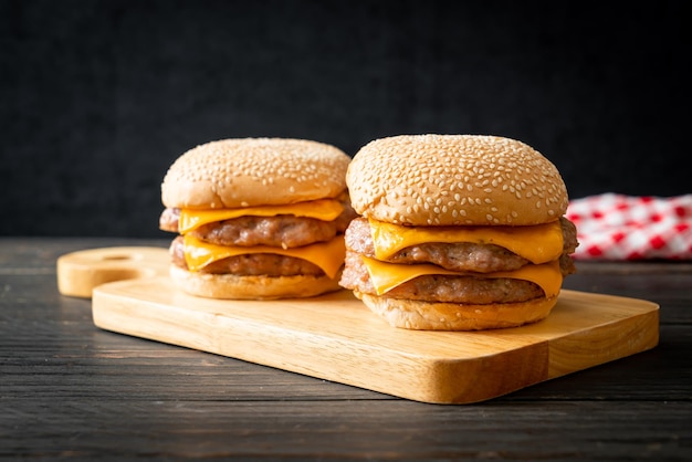 pork hamburger or pork burger with cheese on wooden board