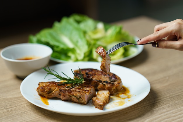 Pork juicy steak grill with vegetables and spices.