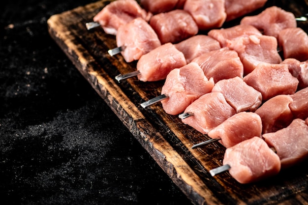 Pork kebab raw on a wooden cutting board