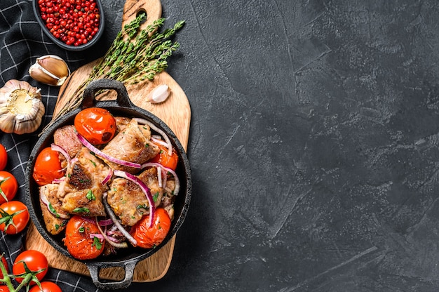 Pork kebab with tomato and pepper in a pan