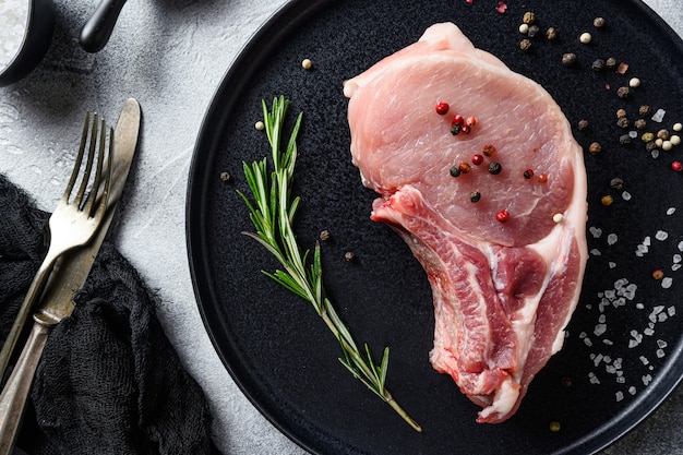 Pork meat cutlet on black round plate