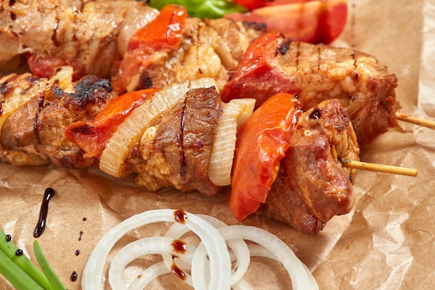 Pork meat kebab with sauces and vegetables