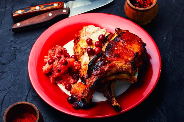 Pork meat with apple sauce on the plate