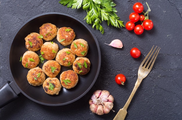 Pork meatballs with parsley in pan Top view