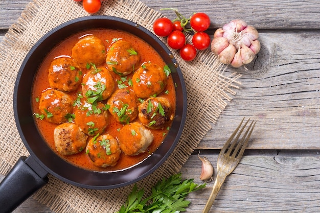 Pork meatballs with parsley in pan Top view