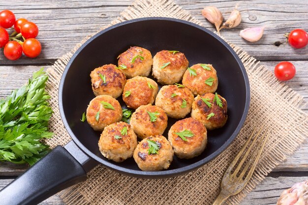 Pork meatballs with parsley in pan