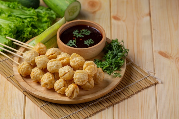 Pork meatballs on the wooden surface.