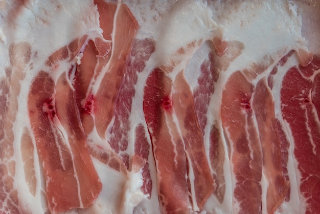 Pork raw meat slides on dish at BBQ. restaurant