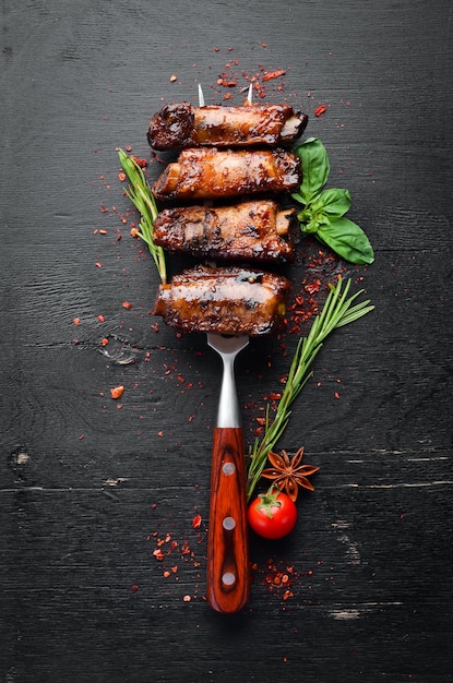 Pork ribs on the fork On a wooden background Top view Free space for your text