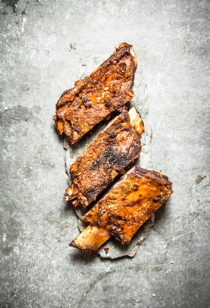 Pork ribs grill on a stone background