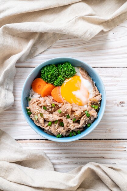 Pork and rice bowl with onsen egg and vegetable