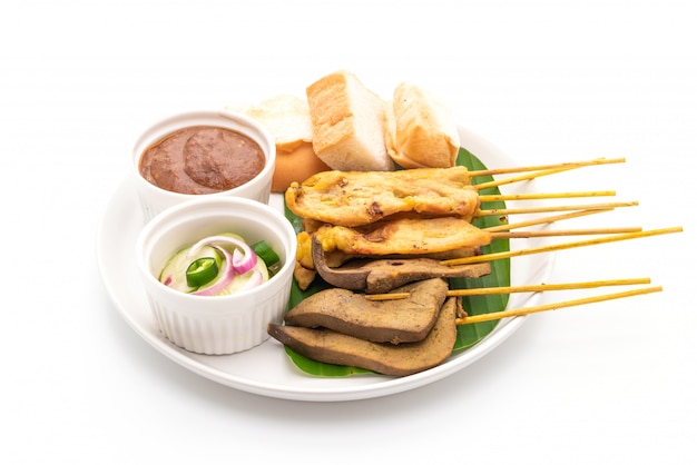 Pork satay with peanut sauce and pickles