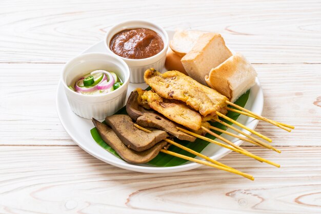 Pork satay with peanut sauce and pickles