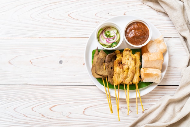 Pork satay with peanut sauce and pickles