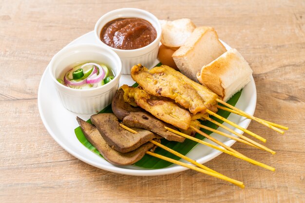 Pork satay with peanut sauce and pickles