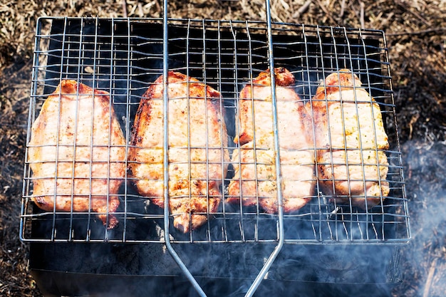 Pork steak on the grill in the smoke