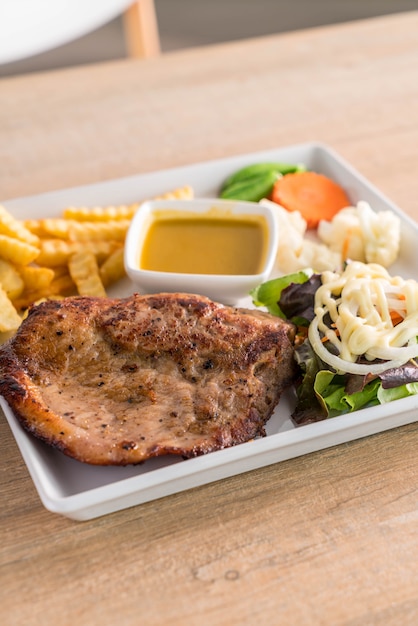 pork steak with french fries and salad