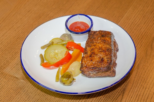 pork steak with pickled vegetables and sauce