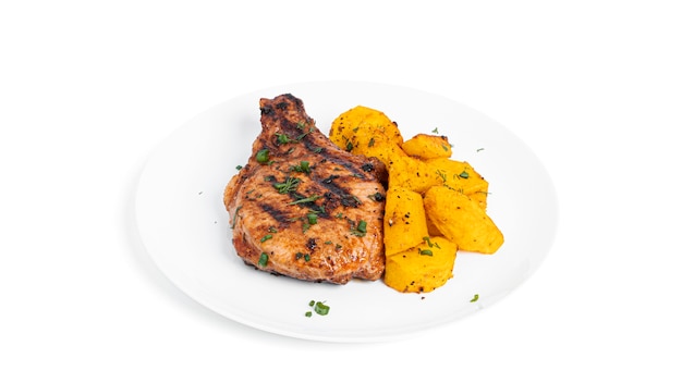 Pork steaks in sauce and baked potatoes on plate isolated.