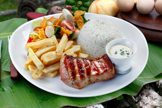 Pork with rice and potatoes salad