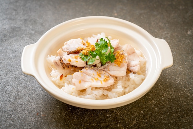 porridge or boiled rice soup with fish bowl