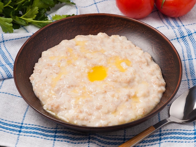 Porridge of several types of cereals poured with butter