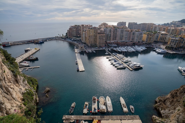 Photo port de fontvieille in azur coast on sunrise with blue sky cloud. precious apartments and harbor with luxury yachts in the bay,monte carlo,monaco,europe