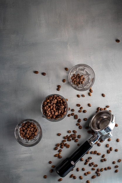 Photo porta filter and coffee beans on gray backgroundopy spacevertical format