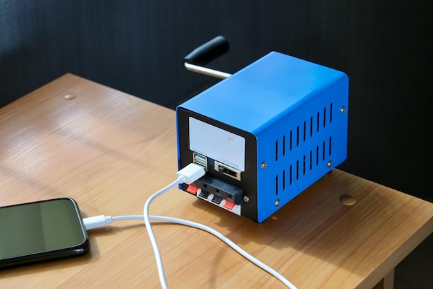 Portable electricity generator usb cable is connected to\
smartphone for emergency situation