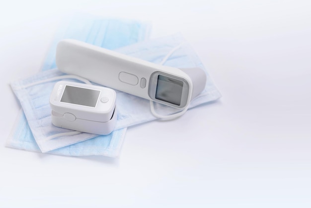 Portable Pulse Oximeter on Background face mask to monitor oxygen level at home