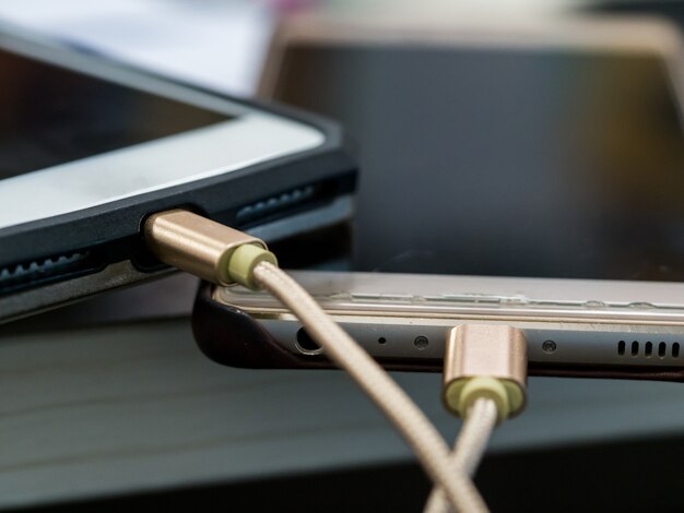 Portable of smart phones  on the table for charging