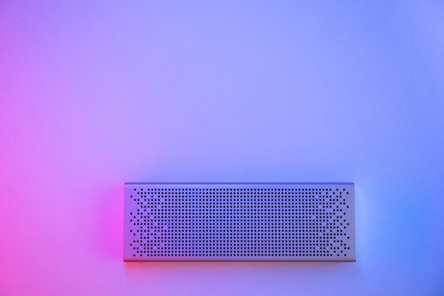 Portable speaker on a colored background