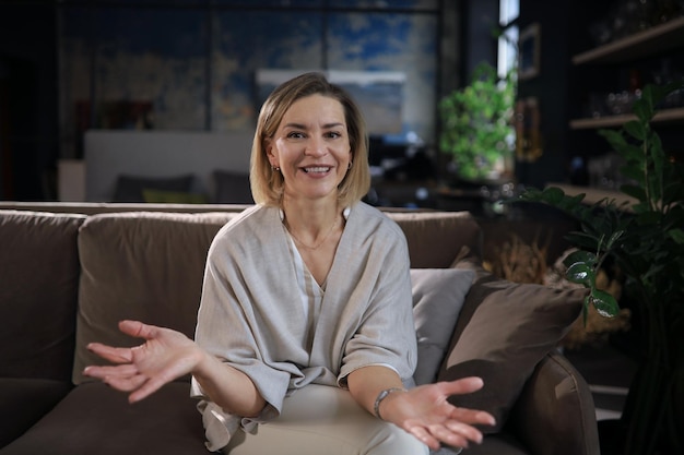 Portait of smiling beautiful middle aged woman looking at camera making video call job interview or online dating