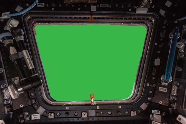 Porthole of space station isolated on green