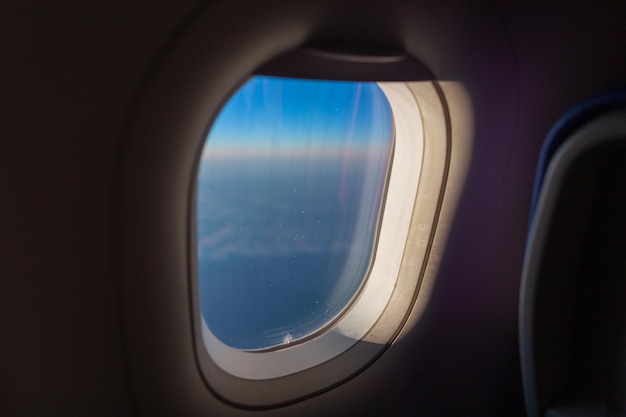 Porthole window in an airplane Airplane flying travel