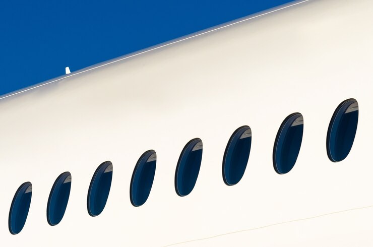 Photo portholes on white modern airplane and sky