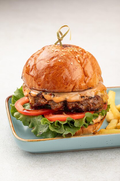 Portion of beef burger with french fries