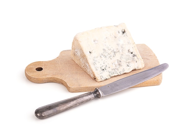 Portion of blue cheese on cuttin board with knife