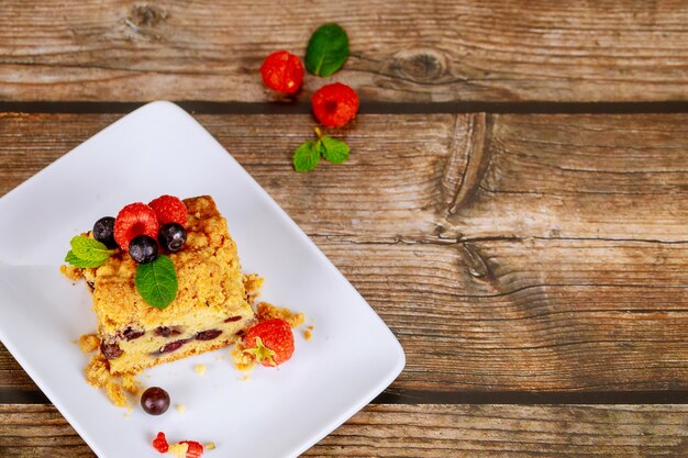 Portion of blueberry coffee cake on wooden surface