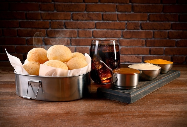 Portion of cheese bread - traditional brazilian food with cheddar, curd and dulce de leche