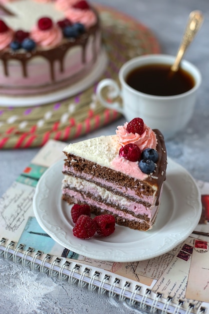 portion of chocolate cake on plate and notebook