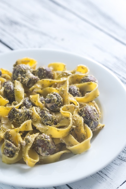 Portion of creamy mushroom pasta with pesto