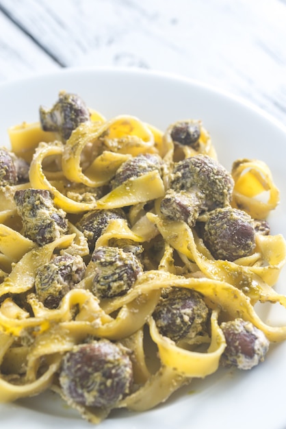 Portion of creamy mushroom pasta with pesto