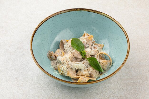 Portion of fettuccine pasta alfredo with chicken