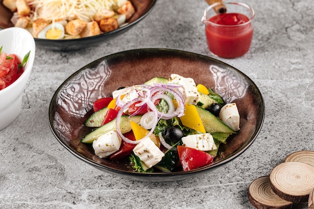 Portion of fresh greek salad on gray backgound