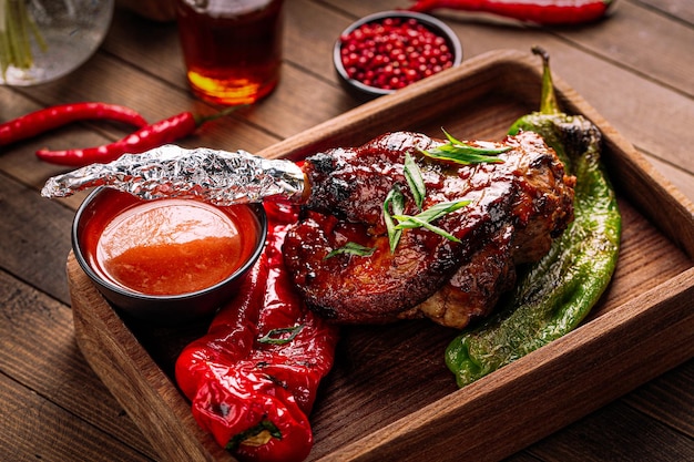 Portion of gourmet cooked lamb shank with peppers