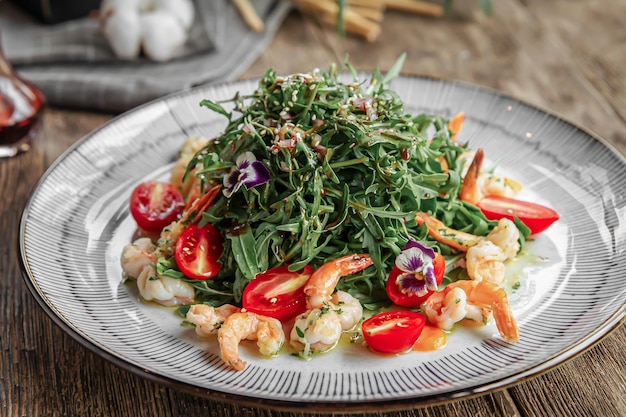 Portion of gourmet shrimp and arugula salad