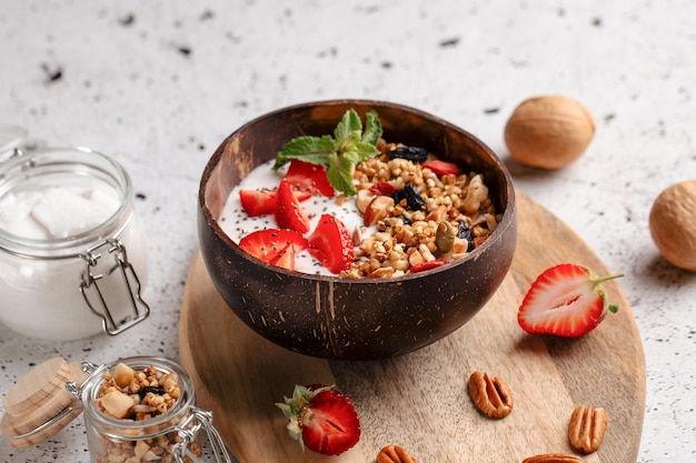 Portion of granola with yogurt and strawberries