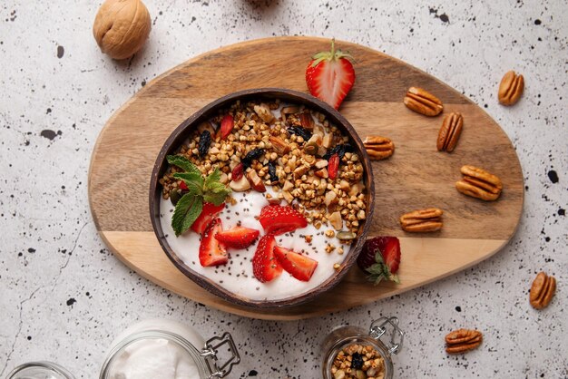 Portion of granola with yogurt and strawberries